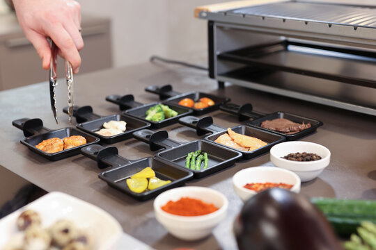 portion cooking vegetables, meat, fish, broccoli, asparagus in the kitchen