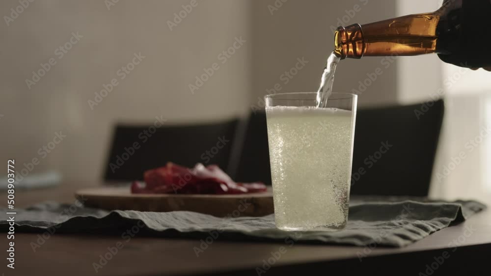 Wall mural slow motion pour ginger drink in tumbler glass on table with copy space