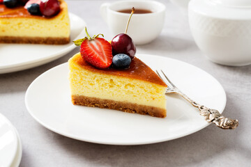 Slice of Souffle cheesecake dessert with fresh berries .