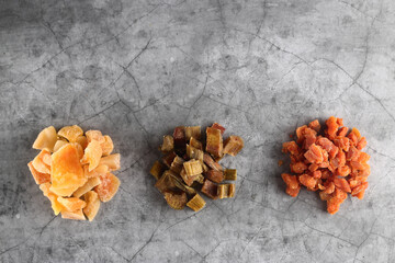 candied rheum, pumpkin and cantaloup isolated on grey background flat lay
