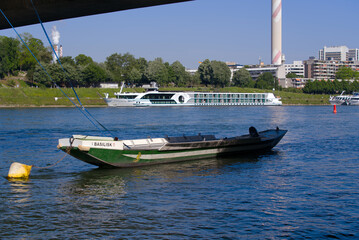Moored wooden boat at Johanniter Bridge on Rhine River at City of Basel on a sunny spring day. Photo taken May 11th, 2022, Basel, Switzerland.