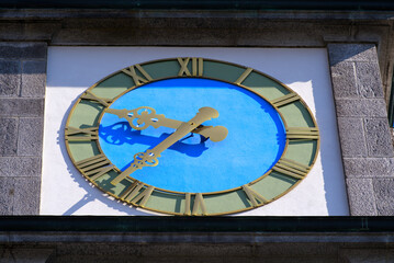 Fototapeta premium Close-up of clock at white apostolic church at the old town of Basel on a sunny spring day. Photo taken May 11th, 2022, Basel, Switzerland.