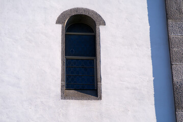 Close-up of window of white apostolic church at the old town of Basel on a sunny spring day. Photo taken May 11th, 2022, Basel, Switzerland.