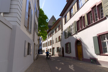 Fototapeta na wymiar Alley with historic medieval houses at the old town of Basel on a sunny spring day. Photo taken May 11th, 2022, Basel, Switzerland.