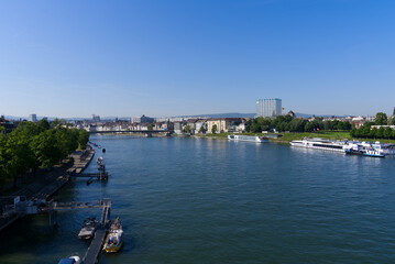 Fototapeta premium Aerial view over Rhine River with skyline of City of Basel on a sunny spring day. Photo taken May 11th, 2022, Basel, Switzerland.