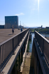 Bridge named Dreirosenbrücke with tramway and pedestrians at City of Basel on a sunny spring day. Photo taken May 11th, 2022, Basel, Switzerland.