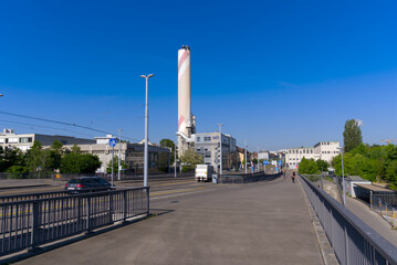Bridge named Dreirosenbr&uuml;cke with tramway and chimney of incineration plant in the background at City of Basel on a sunny spring day. Photo taken May 11th, 2022, Basel, Switzerland.