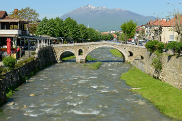 People walking over the old bridge of Prizren on Kosovo