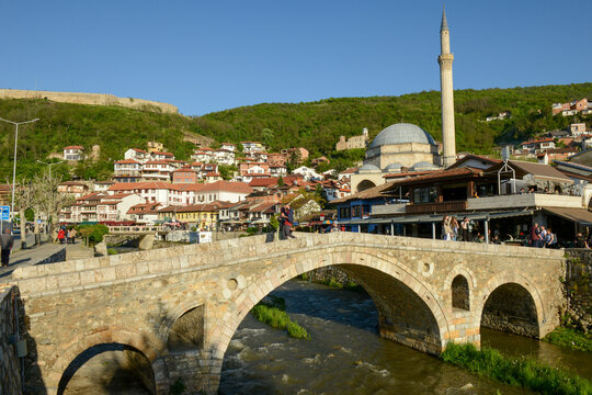 People walking over the old bridge of Prizren on Kosovo