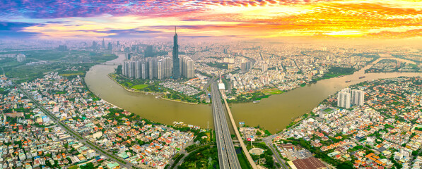 Top view aerial of center Ho Chi Minh City at sunset scene with development buildings, transportation, energy power infrastructure. Financial and business centers in Vietnam. View from District 2