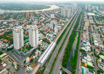 Top view aerial of a Ho Chi Minh City, Vietnam with development buildings, transportation, energy power infrastructure. Saigon river and center city view from district 2