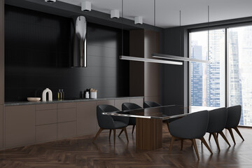 Dark kitchen interior with table and chairs, kitchenware and panoramic window