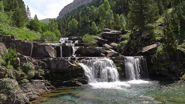 Waterfalls of pure and clean water on the rocks in the Gradas de Soaso, Pyrenees Spain.