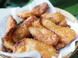 Homemade deep-fried sliced banana in basket, Thai dessert.