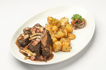 stewed beef short ribs and mushrooms in gravy with roast potatoes