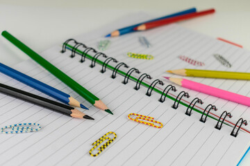 Notepad, pencils and paper clips. Back to school concept.
