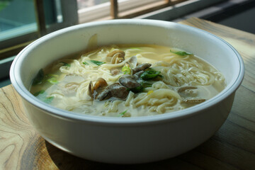 Noodle Soup with seafood is made by boiling thin noodles with seafood, such as shrimp, octopus, and clam, in a baby clam broth.