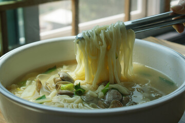Noodle Soup with seafood is made by boiling thin noodles with seafood, such as shrimp, octopus, and clam, in a baby clam broth.