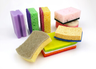 Set of different sponges for washing dishes on a white background. Bright colored sponges for cleaning. Paralon and cellulose sponges for the kitchen.