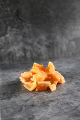 a pile of candied cantaloup (rock melon) isolated on gray background. Image contains copy space