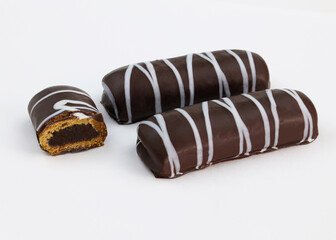 Gingerbread in chocolate glaze with jam. Cookies covered in dark chocolate. Gingerbread with filling on a white background close-up.