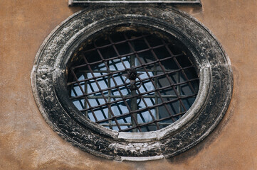 Large round window with bars on the Boim Chapel in Lviv, Ukraine. Decorative element of an old renaissance building.