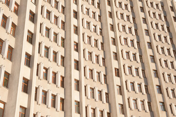 minimalist facade of a skyscraper with a symmetrical pattern of windows