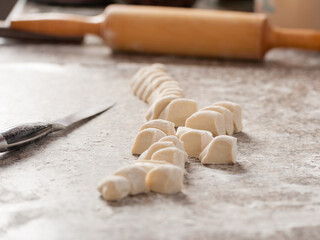 the process of cutting the dough into smaller pieces for cooking
