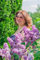 Plus size European or American woman at nature in blue romantic dress, enjoy the life, walks. Life of people xl size, happy nice natural beauty woman. Concept of overweight