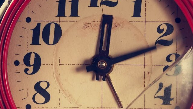 red Old broken rusty clock. The hands of the clock are moving fast. broken glass 4k. close-up.