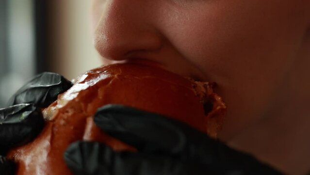 Girl eating a hamburger - close-up
