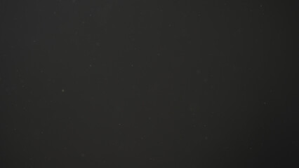 real dust particles in air with back light over black background