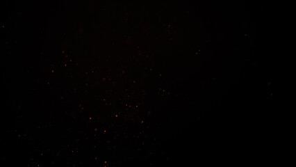 sparks like particles floating in air over black background