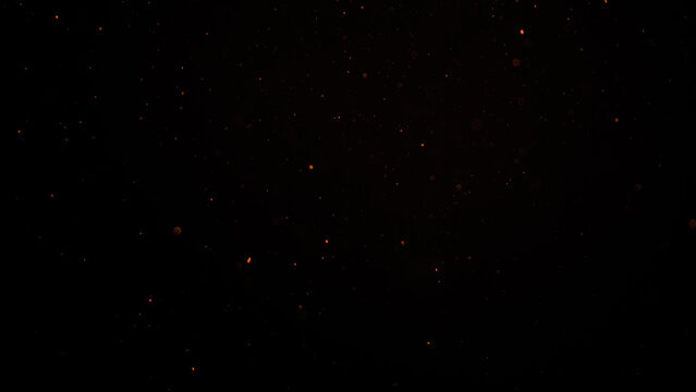 sparks like particles floating in air over black background