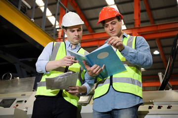 The Caucasian engineer talking and discussing in production line process after check and inspection the machine in factory, professional technician operating or work in manufacturing industrial