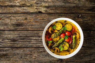 Asparagus soup on wooden table

