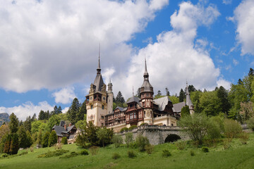 Fototapeta na wymiar Peles castle in Sinaia, Romania, a popular sightseeing destination for tourism in the Carpathian Mountains. Architecture blend between Neo-Renaissance and Gothic Revival.