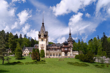 Clouds over Peles castle in Sinaia, Romania, during Spring. Popular sightseeing destination,...