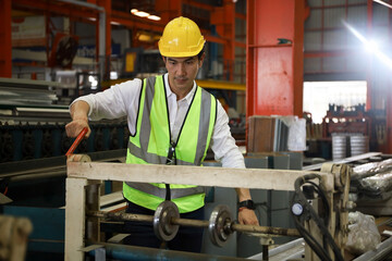 The engineer working and checking in production line in factory, technician or workers operate the machine in industry
