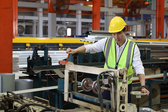 The engineer working and checking in production line in factory, technician or workers operate the machine in industry