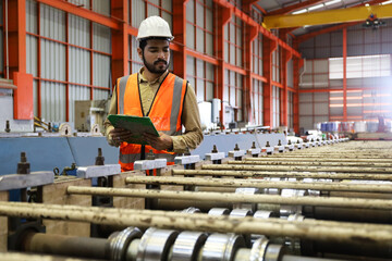 The engineer smart posing in production line process after check and inspection the machine in factory, professional technician operating or work in manufacturing industrial