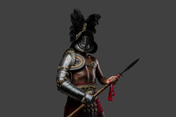 Photo of antique arena fighter of african descent dressed in plumed helmet and armor holding spear.