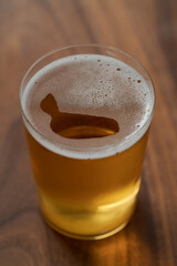 Organic apple cider in tumbler glass on wood table