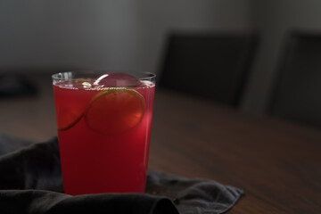 Berry lemonade in tumbler glass on linen napkin