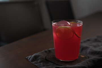 Berry lemonade in tumbler glass on linen napkin