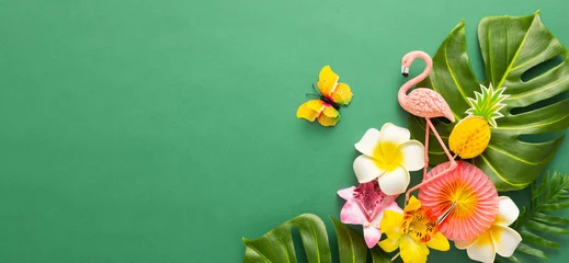 Fototapeten Exotic tropical summer background. Summer beach party concept. Pink flamingo, tropical leaves, orchid flowers and other accessories on green background. Flat lay, copy space. © Svetlana Kolpakova
