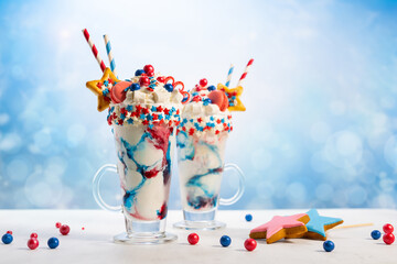 Crazy milk shake with ice cream,whipped cream, marshmallow,cookies and colored candy in glass....