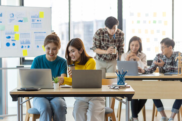 Young people working together in the office. Collaborating with colleagues, discussing, discussing, planning together in the office.