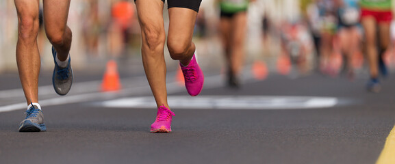 Marathon running race, people feet on city road, runners run urban marathon in the the city