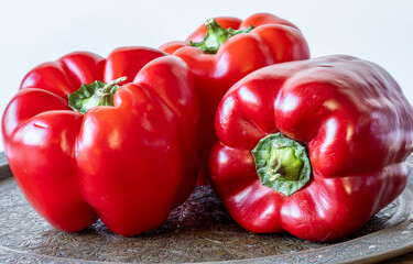 Three red peppers on white background